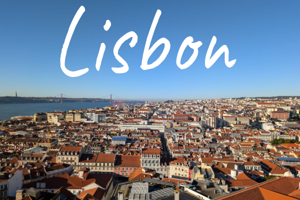 Aerial view of Lisbon's rooftops with a clear blue sky.