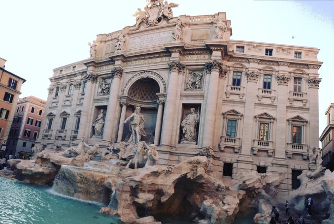 Trevi Fountain in Rome, featuring ornate sculptures and cascading water.