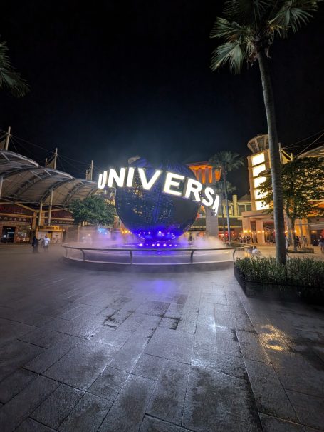 Night view of Universal Studios entrance with a large illuminated globe.