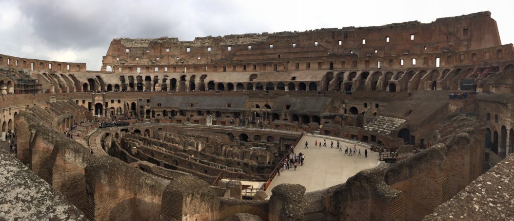 Panoramic view of the Colosseum's interior, showcasing ancient stone architecture.