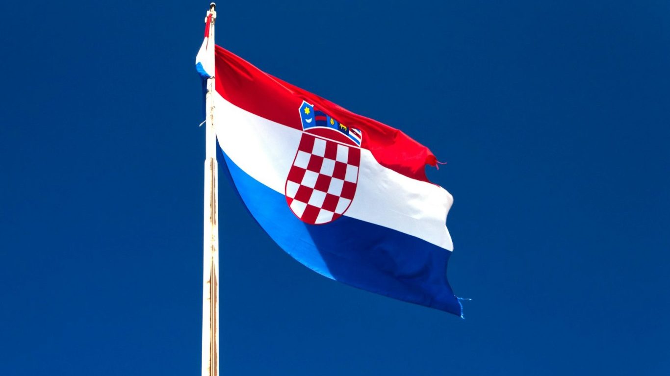 Flag of Croatia, featuring red, white, and blue stripes with a coat of arms in the centre.