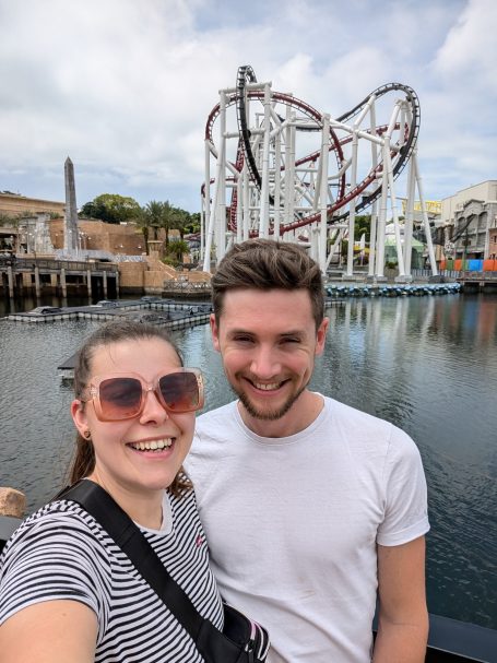 I&B's Founder & Husband posing in front of the Battlestar Galatica rollercoster at Universal Studios in Singapore