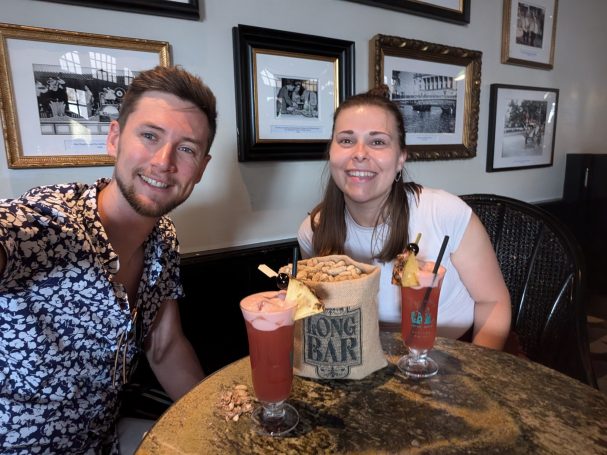 I&B's Founder and Husband posing with Singapore Sling Cocktails at Raffles Hotel