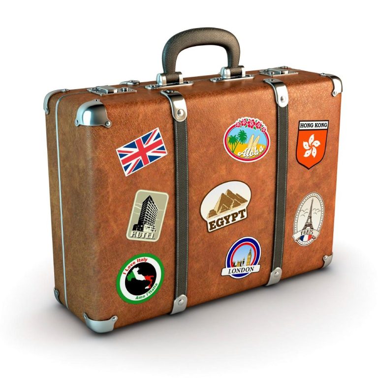 Brown vintage suitcase with travel stickers from various destinations.