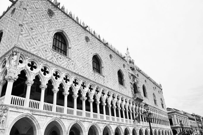 Black and white view of the Doge's Palace with detailed Gothic architecture.