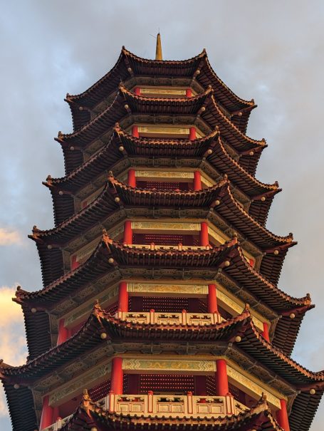 View of Chin Swee Caves Temple @ Genting Highlands in Malaysia from the ground level, looking at a cloudy sky at sunset