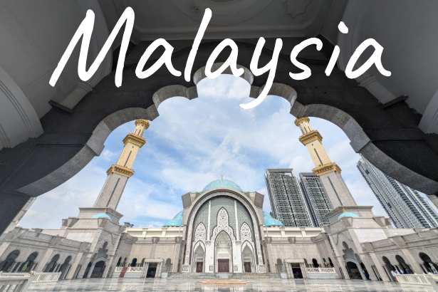 View of a mosque with tall minarets and modern buildings in the background, labelled "Malaysia."